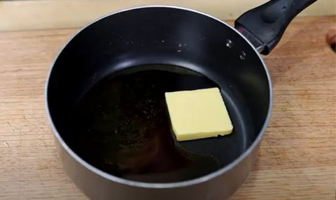 This image shows Butter, honey, apple cinnamon glaze combine in a bowl.
