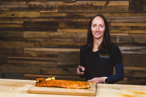 This image shows Rhiannon preparing to slice the Salmon