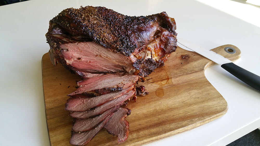 Cutting a cooked leg of lamb