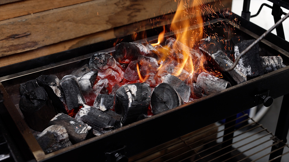 This image shows lit charcoal for cooking chicken wings