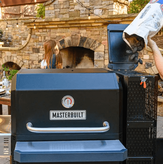 Adding charcoal to a Masterbuilt Gravity Feed Smoker for outdoor BBQ cooking.