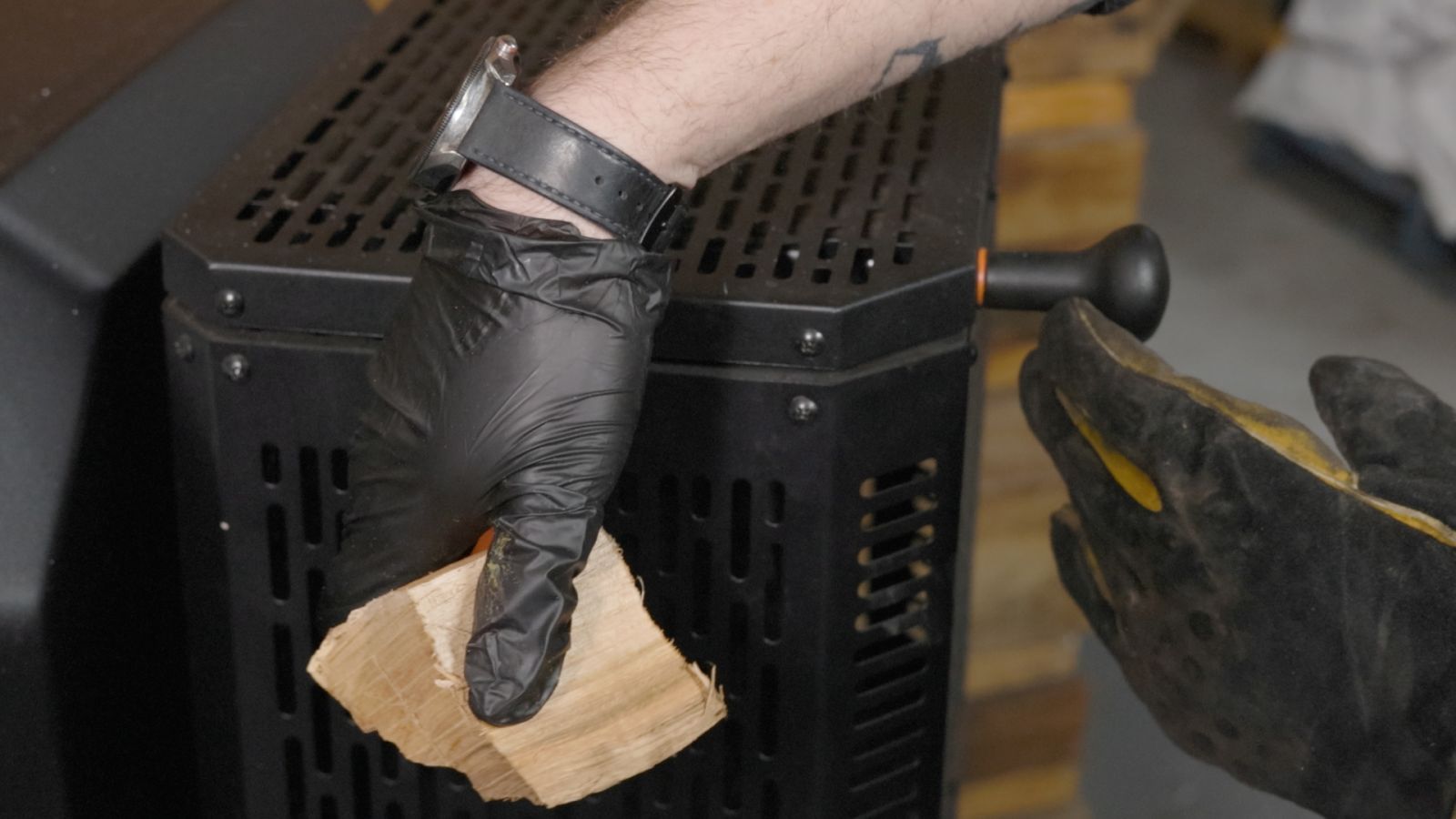 Adding wood chunks to a Masterbuilt Gravity Feed Smoker for extra smoke flavour during BBQ cooking