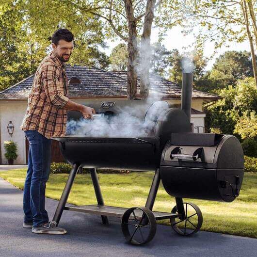 Offset smoker cooking outdoors