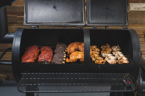This_image_shows_Flaming_coals_offset_smoker_being_used_in_cooking_various_kinds_of_meat