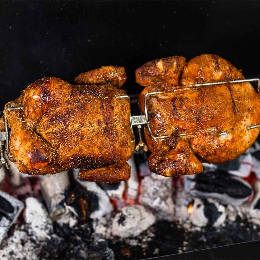 This photo shows a Chickens cooking on a Mini Spit Rotisserie