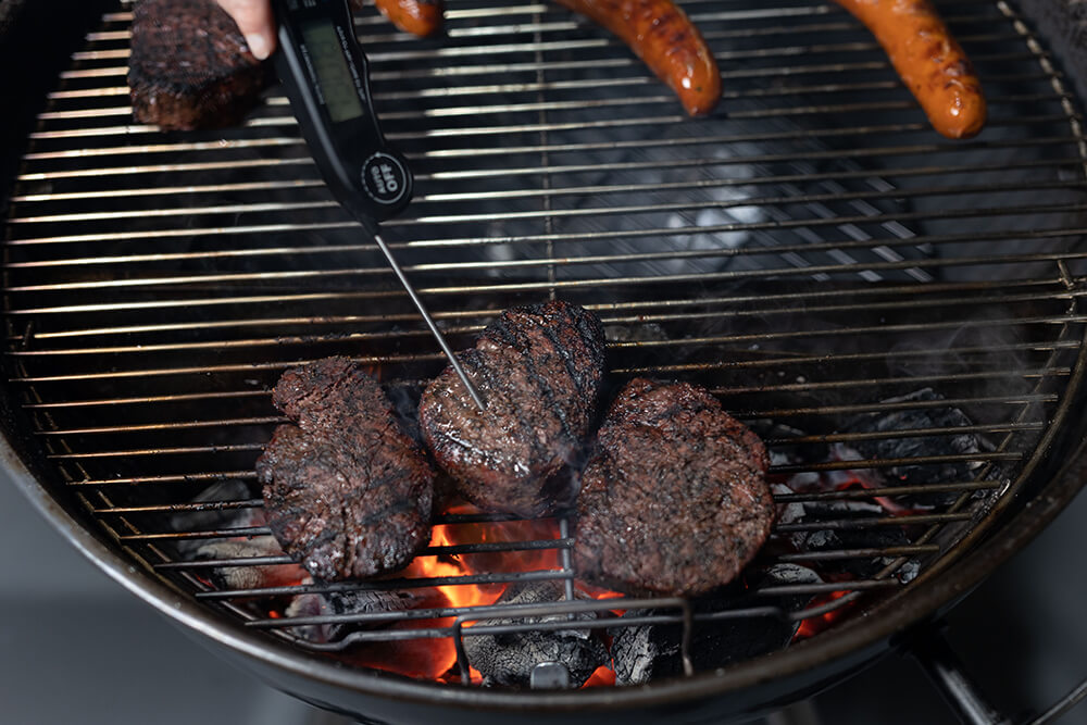 This image shows steak being grilled on SNS kettle BBQ