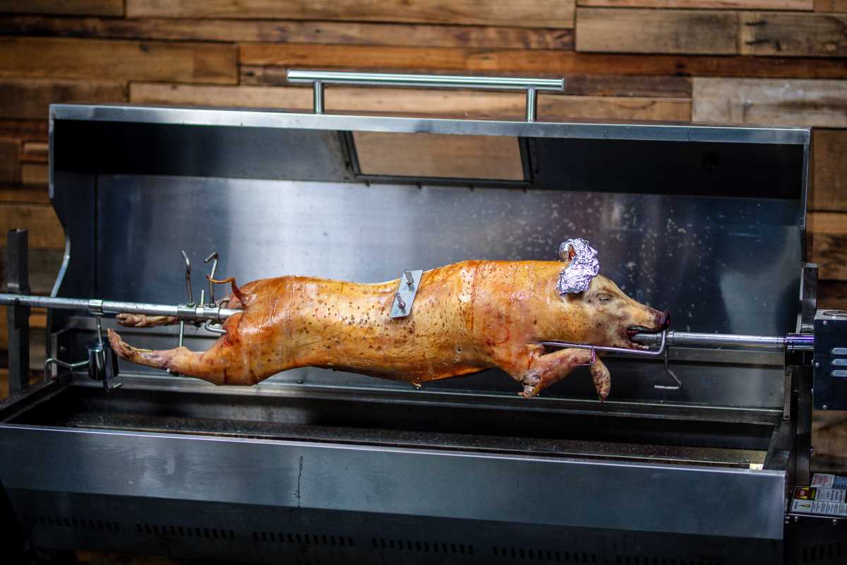 This_image_shows_pig_being_cooked_on_a_spit
