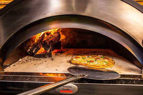 This_image_shows_pizza_being_placed_on_wood_fired_pizza_oven