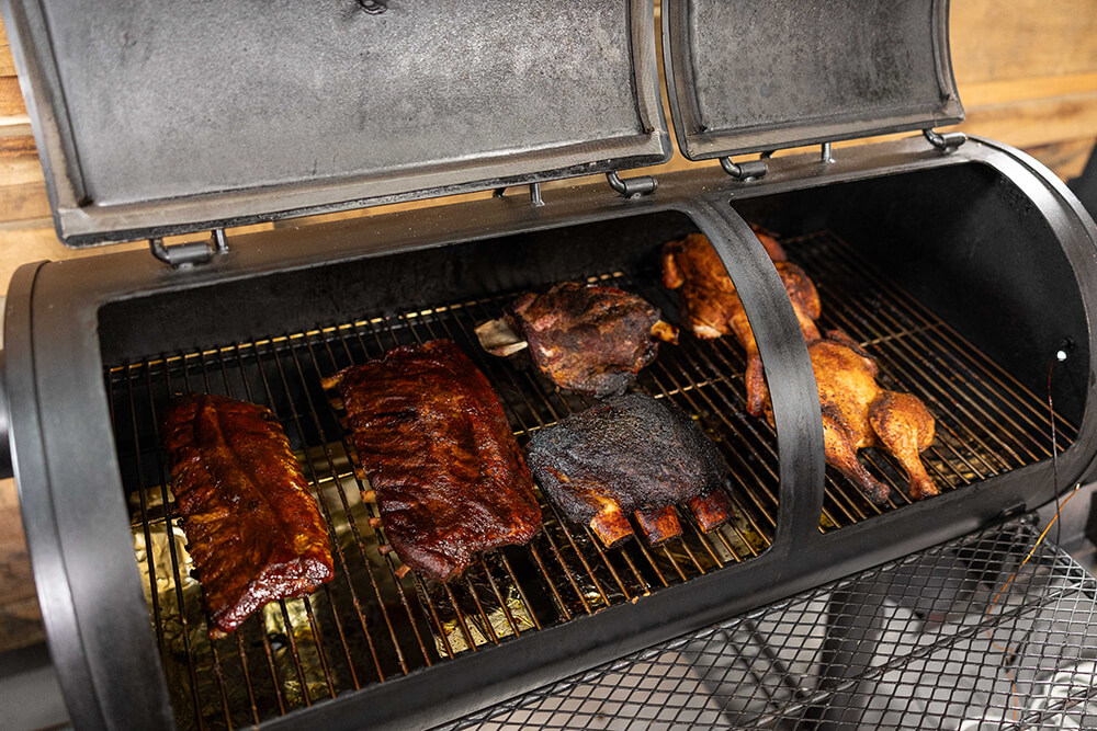This_image_shows_lamb_shoulder_being_placed_on_Offset_smoker