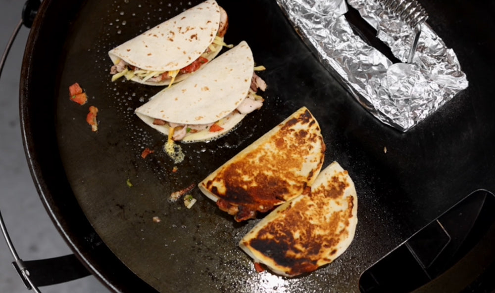 This_image_shows_tacodillas_being_placed_on_SNS_plancha