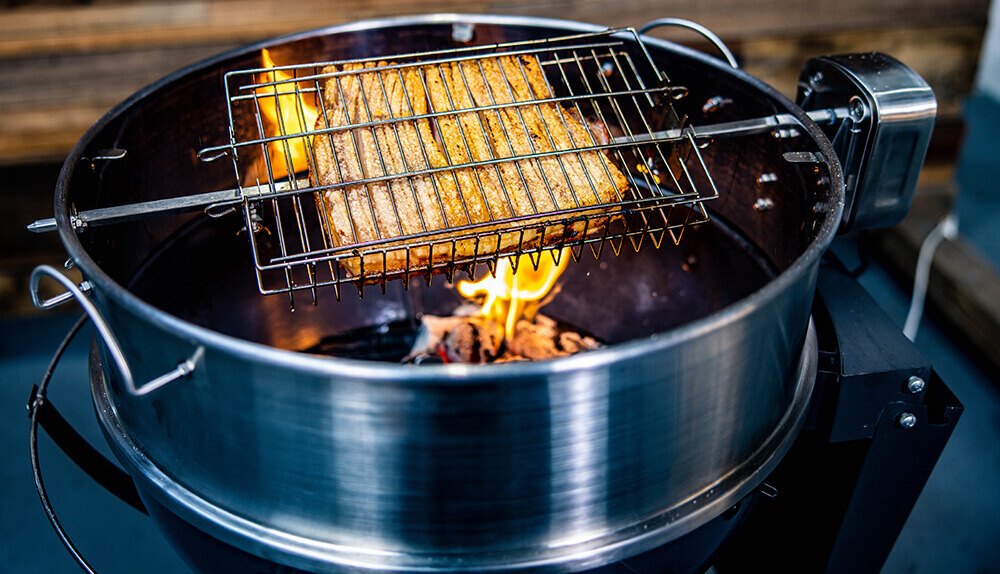 This image shows delicious crispy pork belly being cooked in kettle rotisserie 