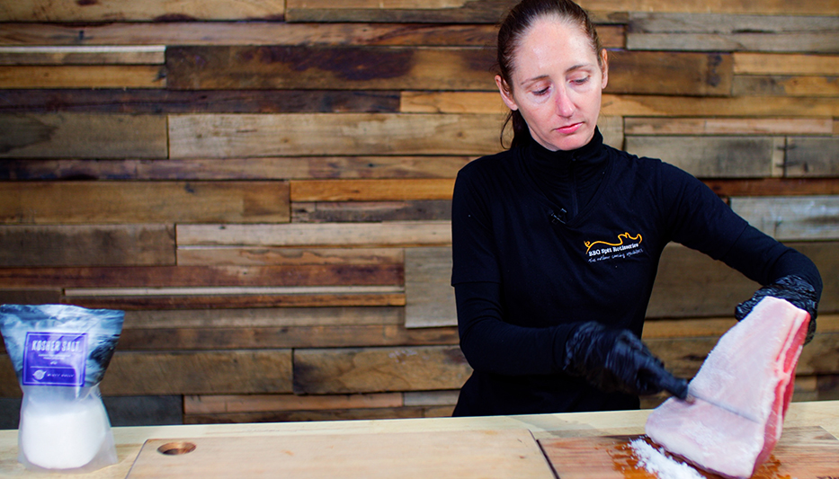 This image shows Rhiannon Peterson scraping Kosher Salt to pork Belly