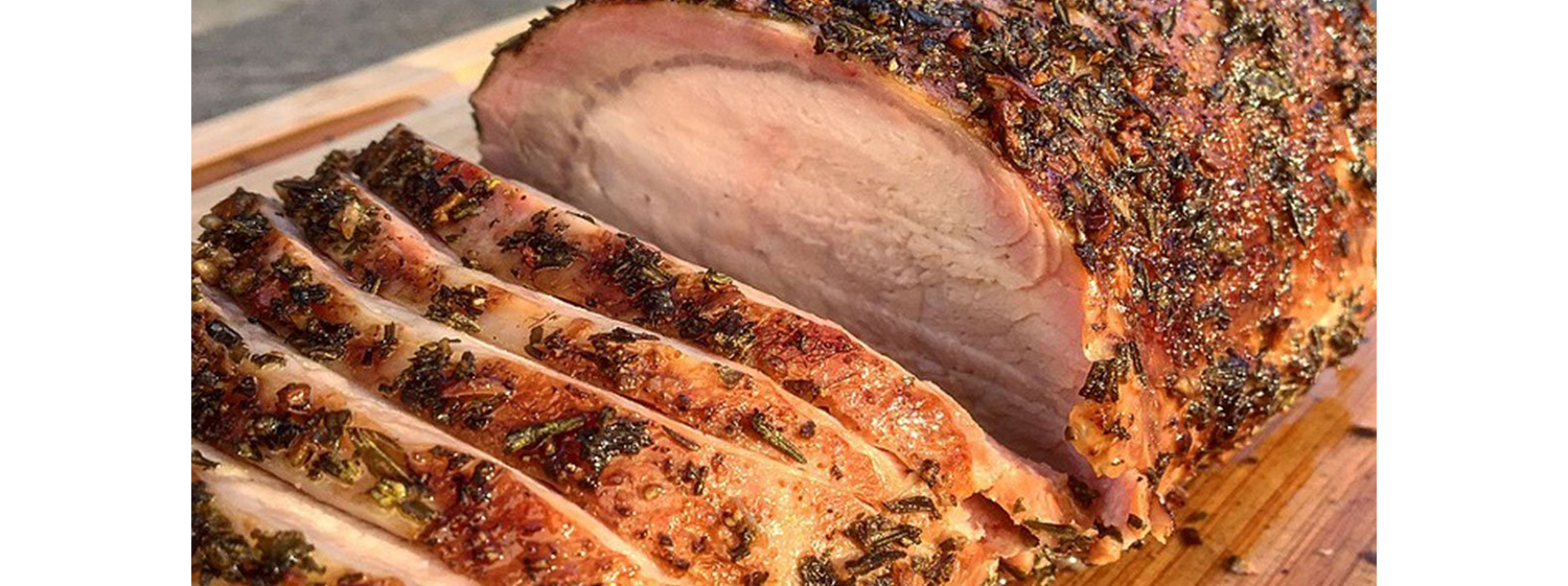 This image shows a sliced pork loin after it was smoked in an SNS Kettle BBQ