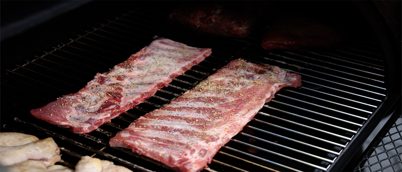This image shows pork ribs on Flaming coals offset smoker
