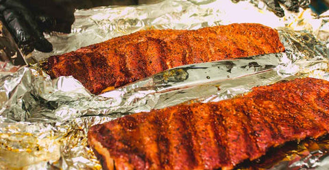This_image_shows_pork_ribs_wrapped_in_aluminum_foil