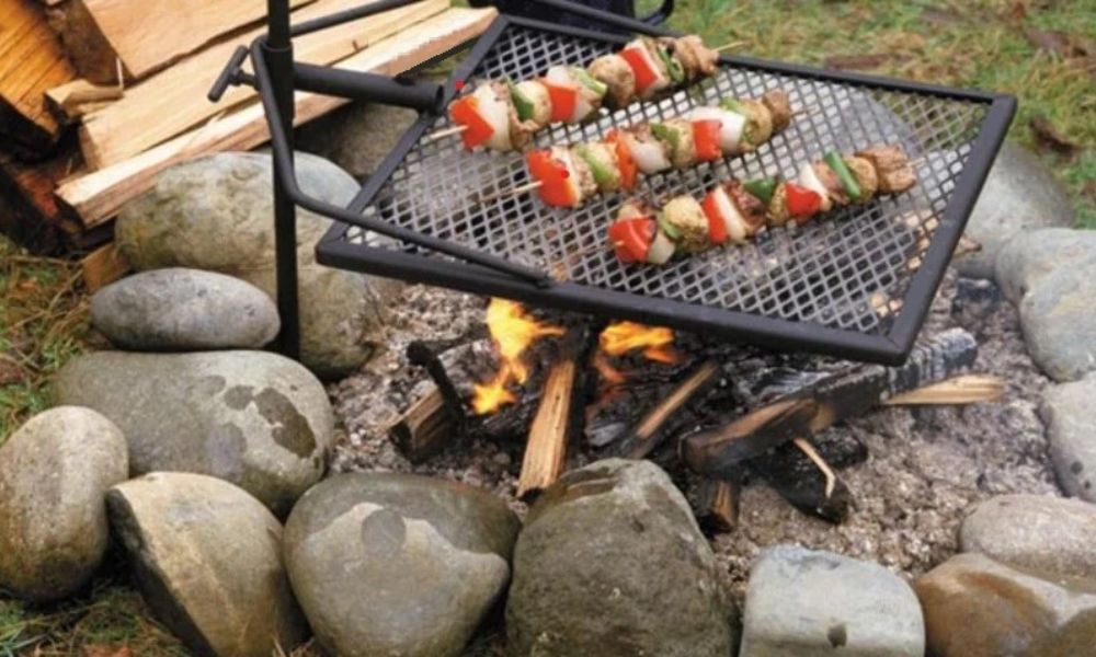 This image shows a cook on a Portable Swinging Camping Grill