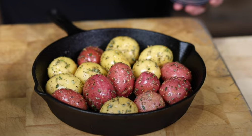 This_image_shows_Potatoes_placed_on_cast_iron_Skillet