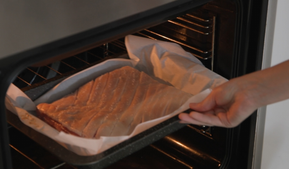 This_image_shows_pork_belly_being_placed_in_the_oven