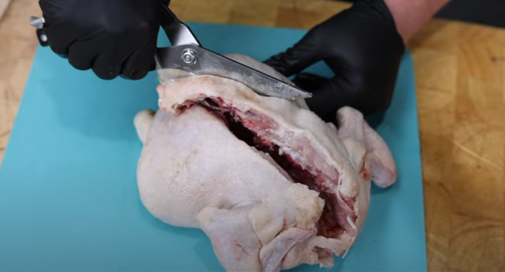 This_image_shows_back_bone_of_the_chicken_being_removed