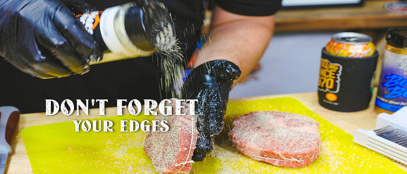 This image shows a man seasoning the steak with white lightning rub. 