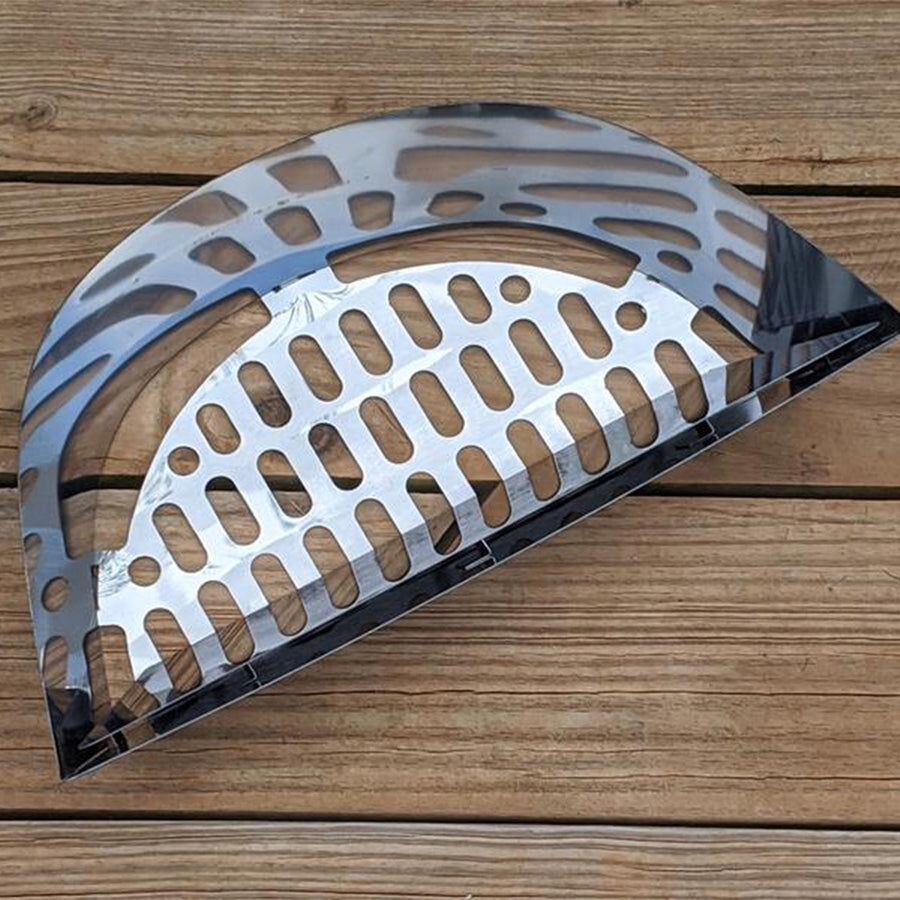 Slow N Sear Charcoal Basket made of stainless steel, designed for efficient fuel placement inside a kettle grill, placed on a wooden surface.