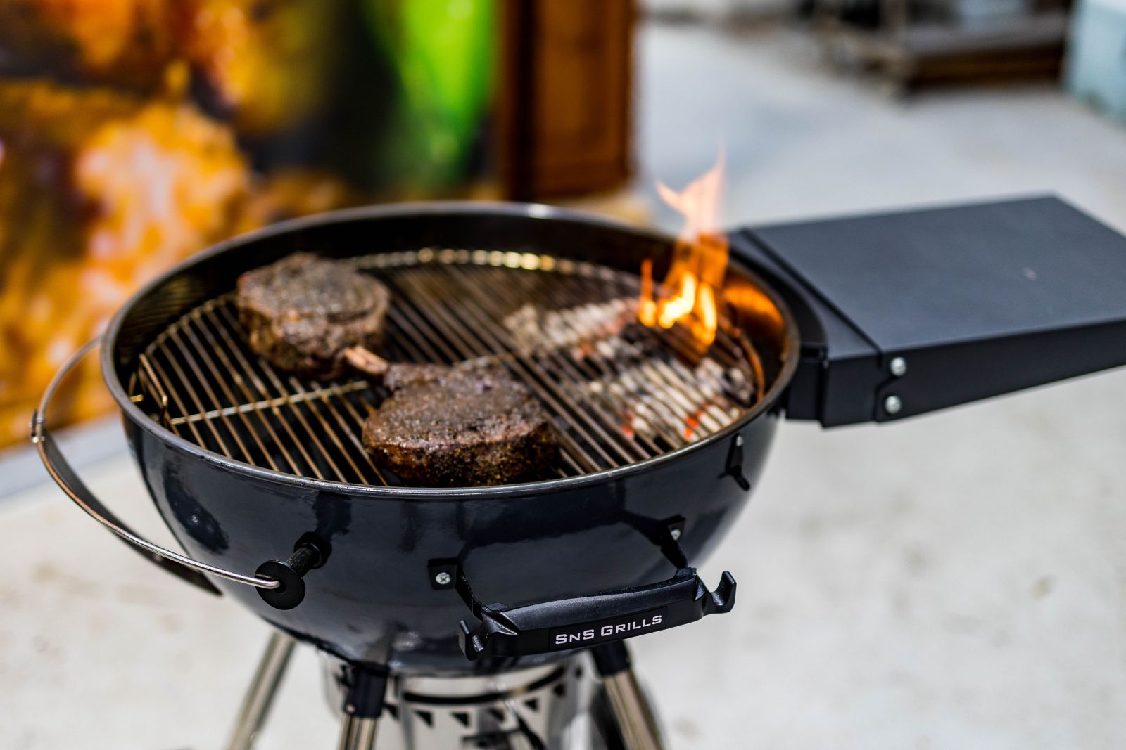 This image shows steak being cooked in a kettle smoker