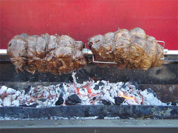 image of beef cooking on a spit roaster