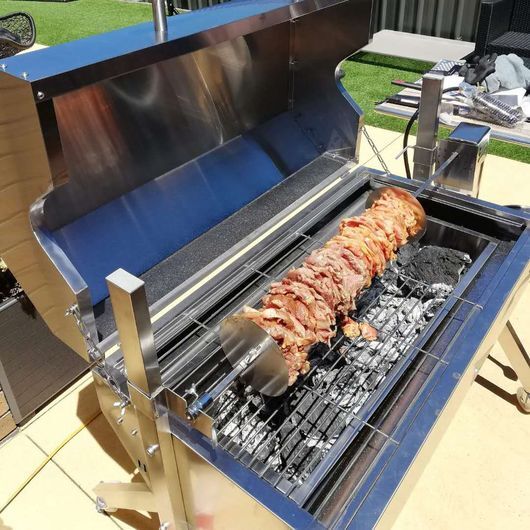 This image shows gyros being cooked on Charcoal Spit Roaster 