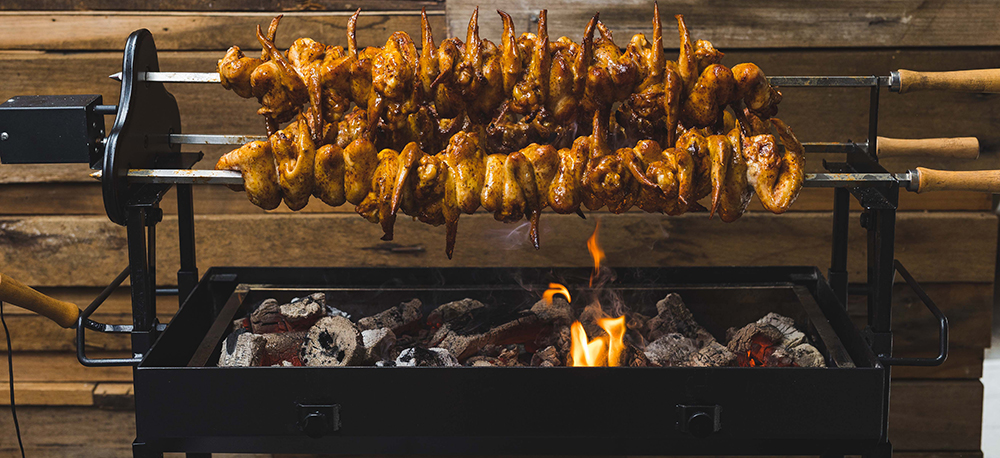 This image shows Super Tasty chicken wings cooked on Flaming coals Cyprus Spit