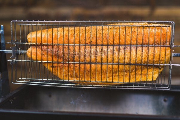 This image shows the salmon with placed on the Rotisserie Basket