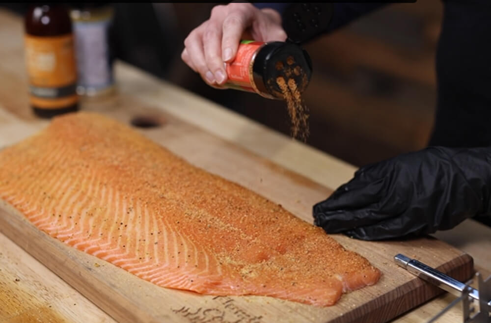 This image shows the Salmon being seasoned with Lanes Chili Lime