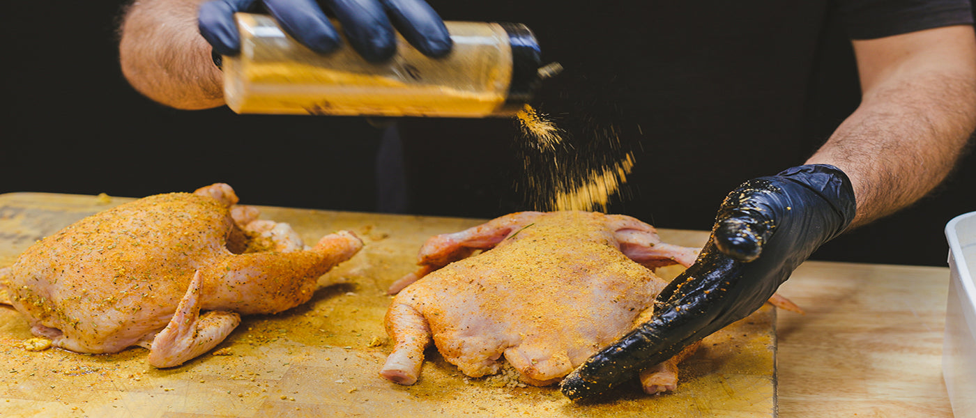 This image shows two whole chicken seasoned with Flaming Coals Rub