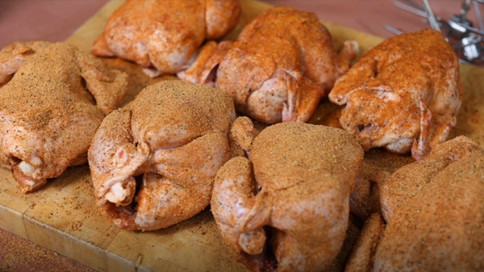 This image shows seven whole chickens seasoned with Flaming Coals Chicken Rub and Charcoal Chicken Rub