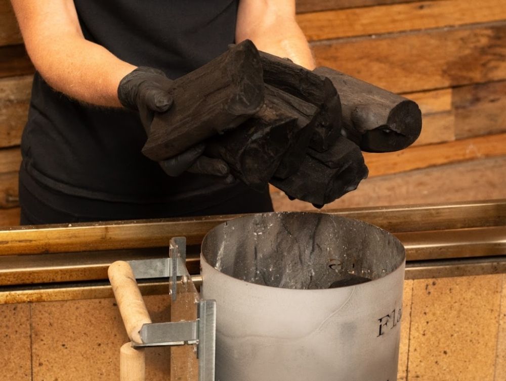 This_image_shows_charcoal_being_added_to_charcoal_chimney