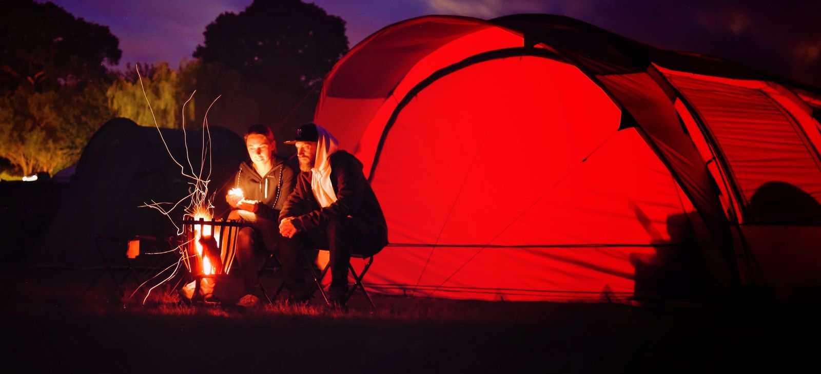 Setting up tent for camping Photo by Jens Mahnke from Pexels
