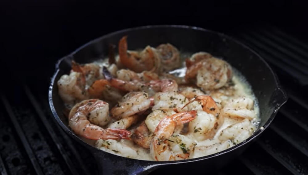 This image shows shrimp being cooked on Cast Iron Skillet