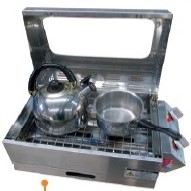 This image shows the sizzler max with the cooking tray installed converting the bbq into a stove top
