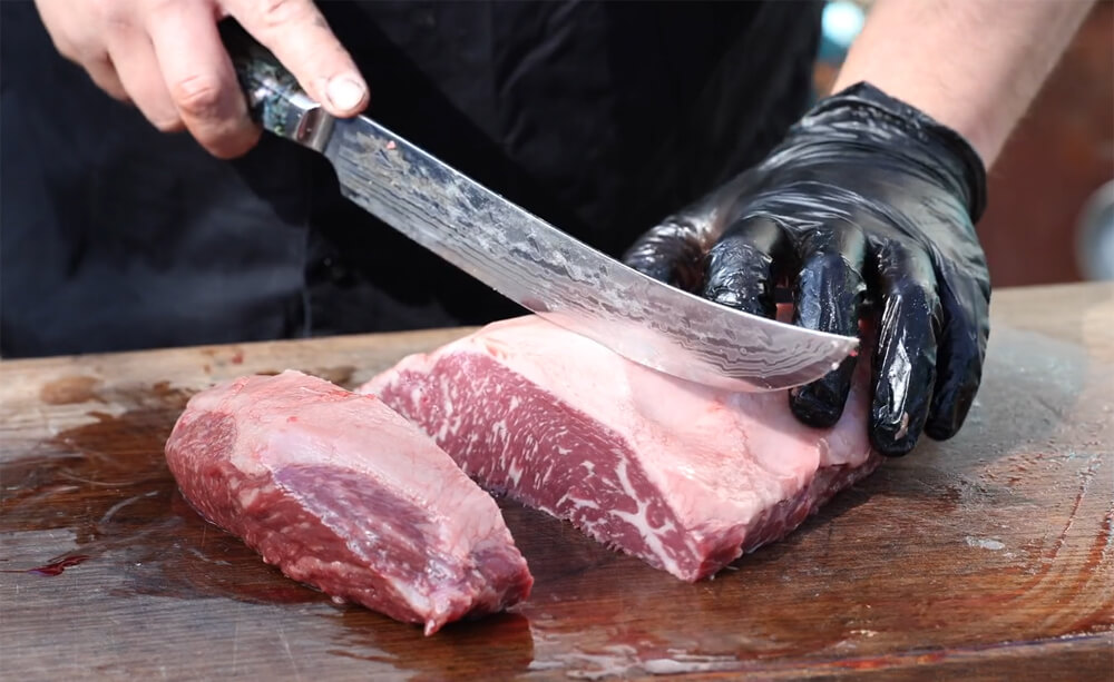 This image shows slicing the rump cap into 2 inch thick slices for Picanha