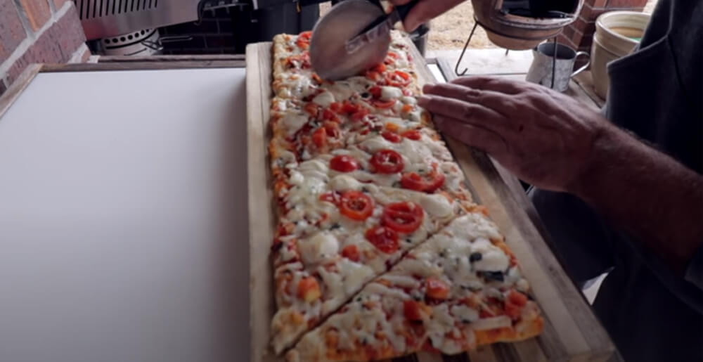 This_image_shows_delicious_Pizza's_Being_Sliced