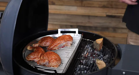 This_image_shows_chicken_being_cooked_on_SNS-kettle_with_wood_chunks