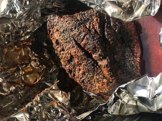 This_image_shows_brisket_being_wrapped_in_foil