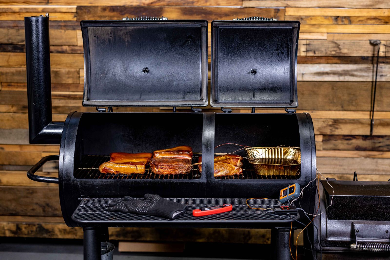 This_image_shows_different_kind_of_meats_being_cooked_on_Flaming_Coals_Offset_Smoker 