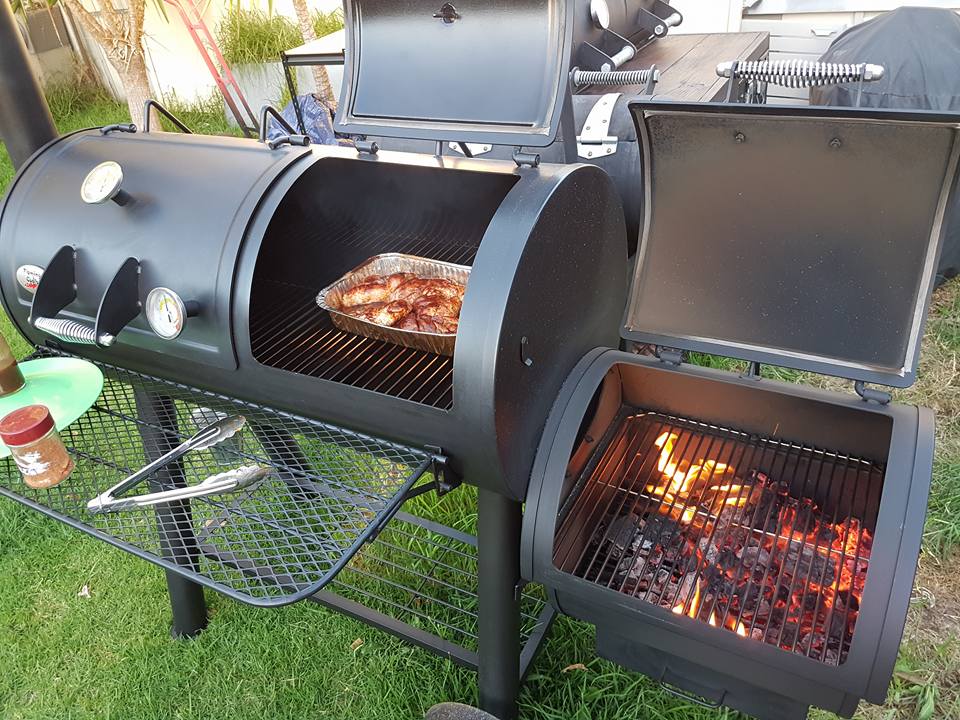 This_image_shows_chicken_smoking_on_Flaming_Coals_Offset_Smoker 