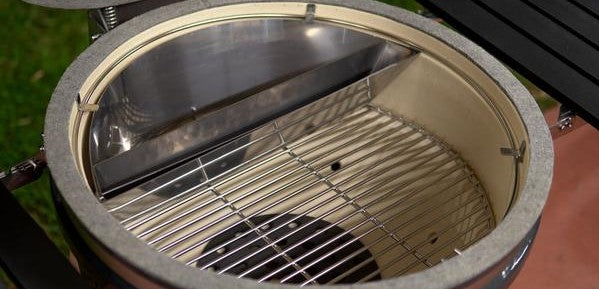 This picture shows the larger Slow N Sear XL in a Kamado