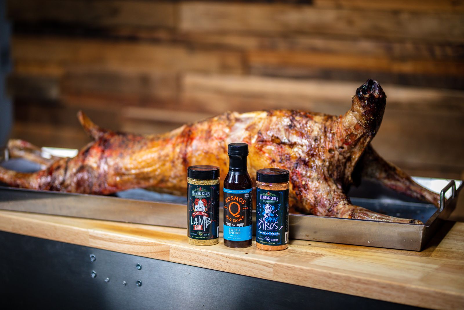 Whole lamb spit roast served with BBQ rubs and sauce on tray