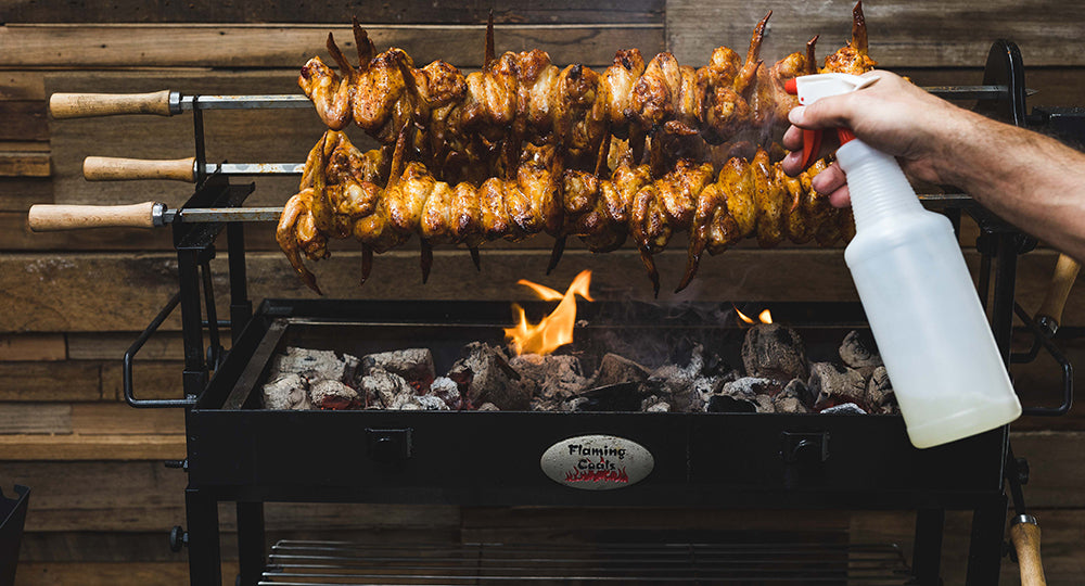 This image shows chicken wings being spritz to avoid drying out