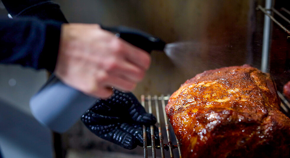 This image shows the pork shoulder is being Spritz