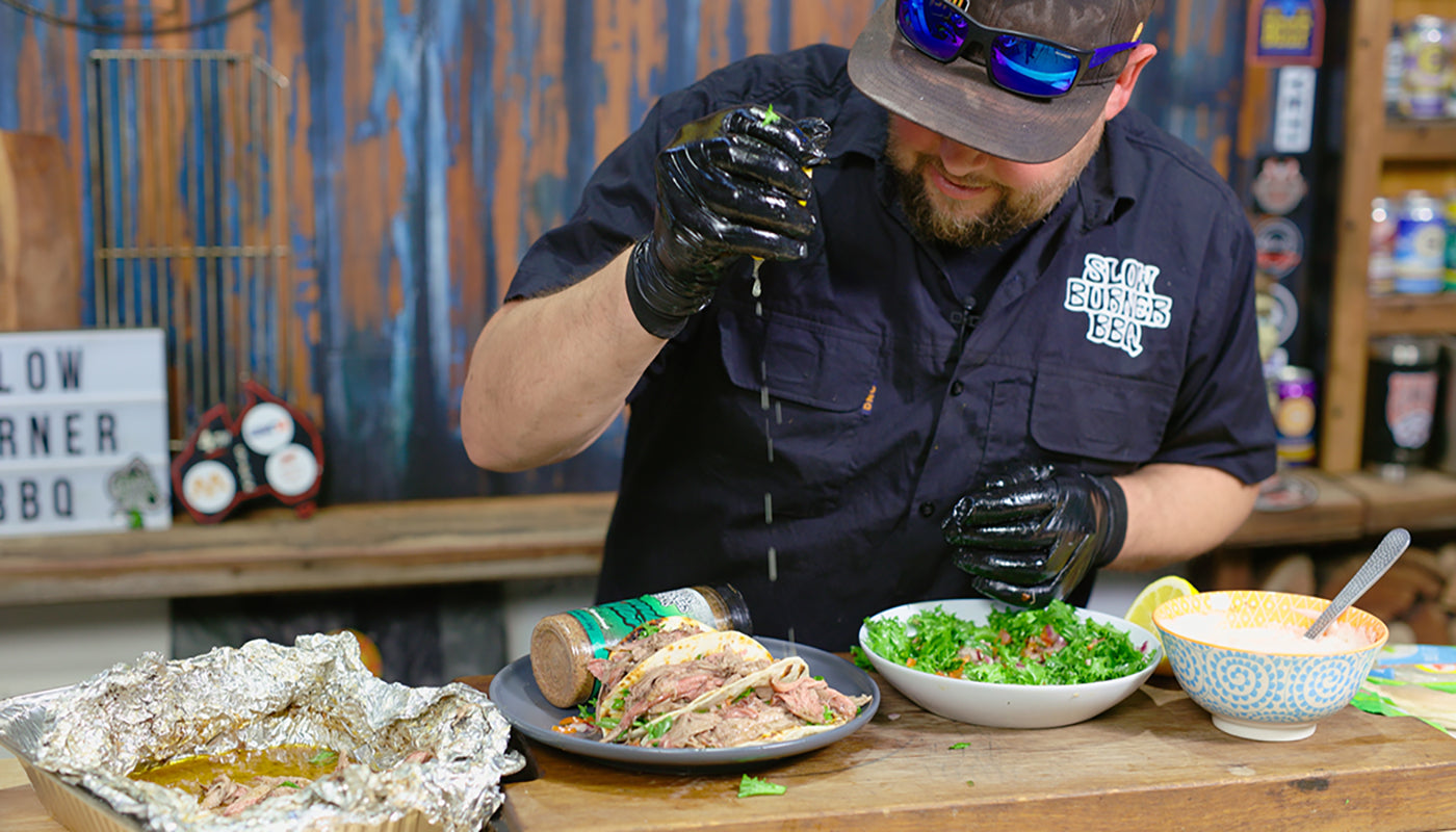 This image shows Westy form Slow Burner Bbq squeezing some lemon juice to the Souvlaco