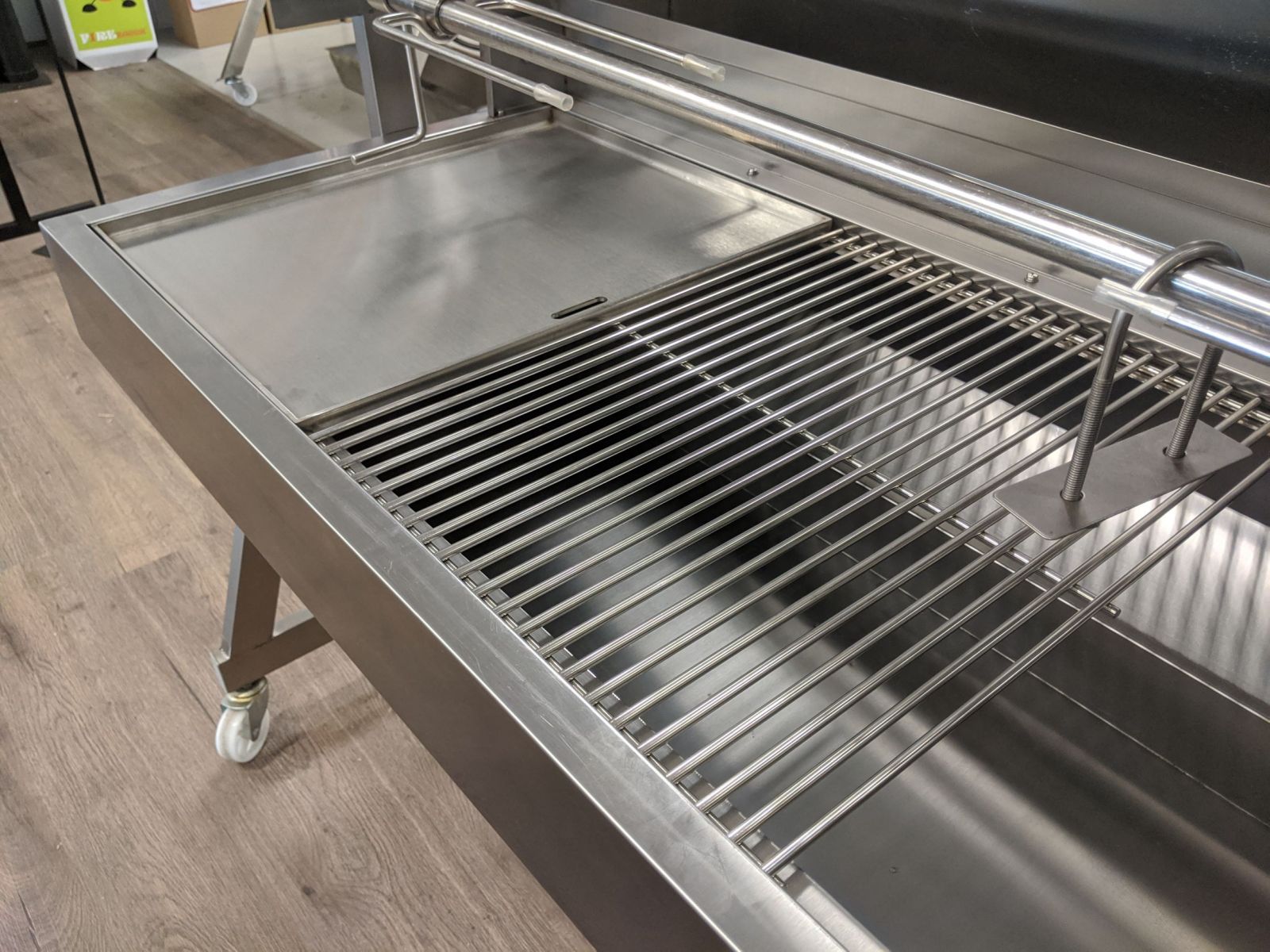 Image of the Stainless Steel BBQ Grill replacing the grill in a BBQ alongside a stainless steel hotplate