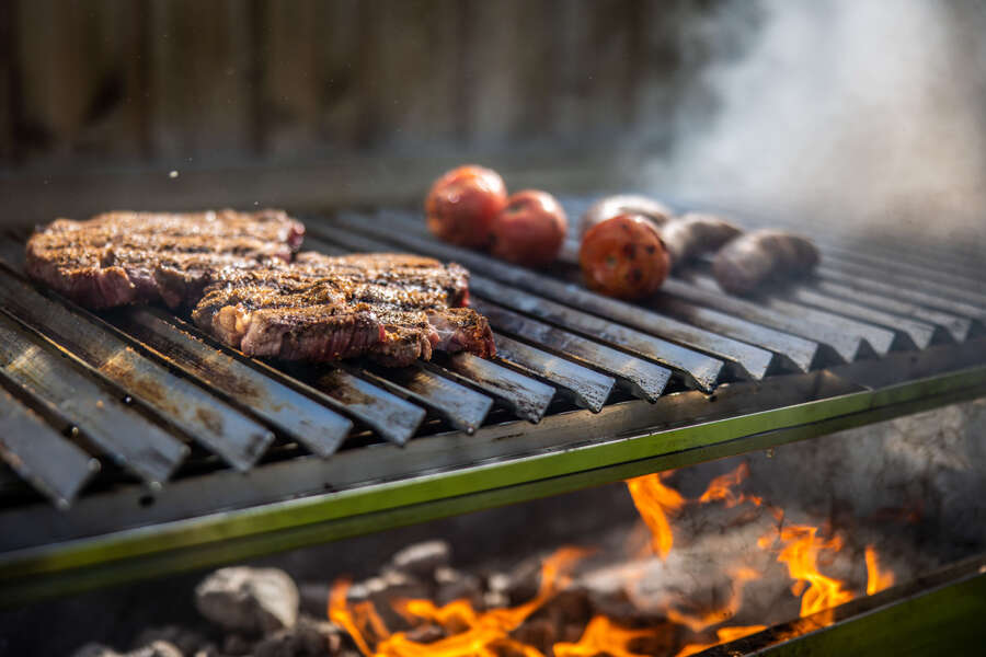This_image_shows_steak_being_cooked_on_parrilla_grill
